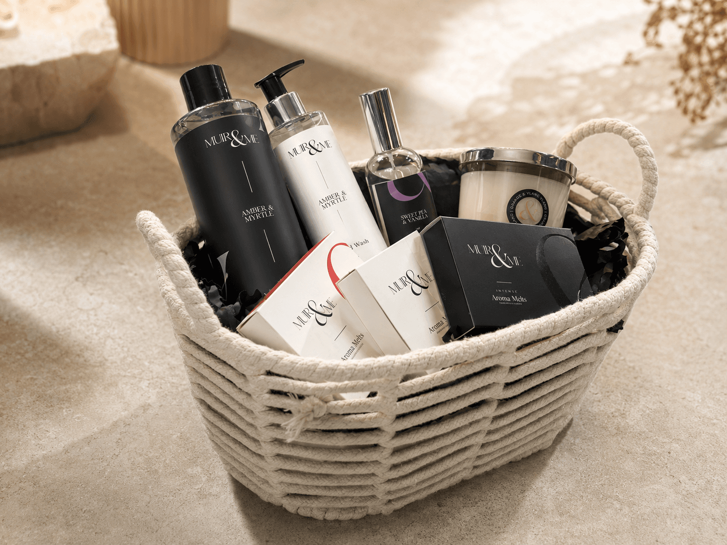 The giveaway hamper: Amber and Myrtle body and hand wash, Sweet Pea and Vanilla room spray, an Orange and Ylang Ylang candle and three sets of aroma melts, in a rope basket