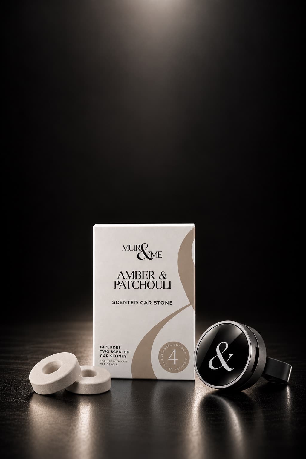 The Car Cradle & Stone starter set: an Amber & Patchouli scented car stone box, two stones and the black cradle